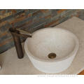 Round beige travertine sink